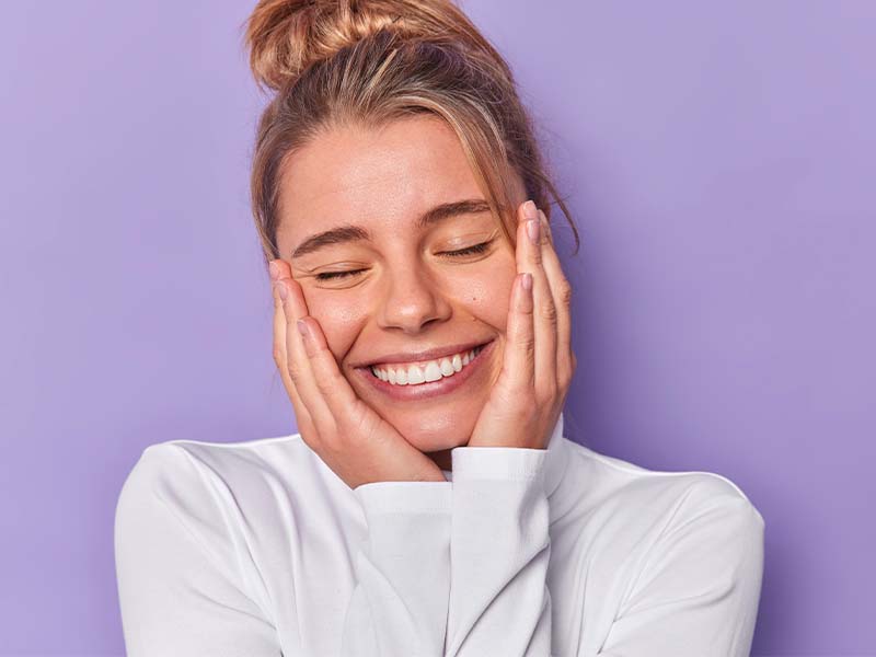 Person smiling for a dental emergency guide