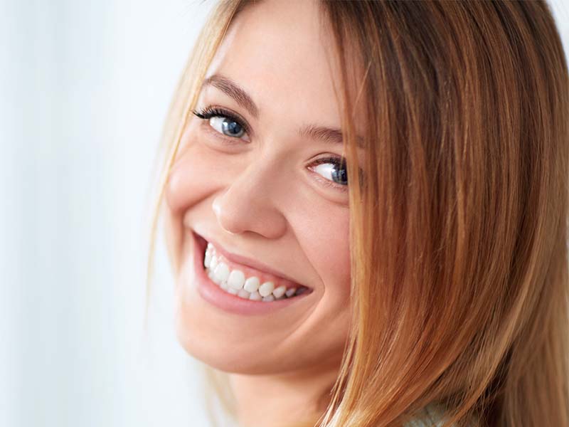 Patients smiling for an intraoral camera guide